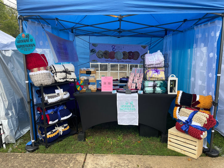 Market setup featuring luxury gourmet sweet treats and handcrafted crochet blankets by Creations of Sophistication